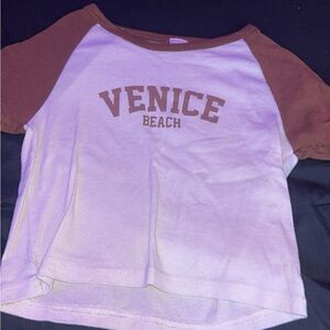A white & brown t-shirt crop top .